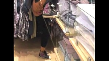 Crayz girl pissing in store - Caught on camera